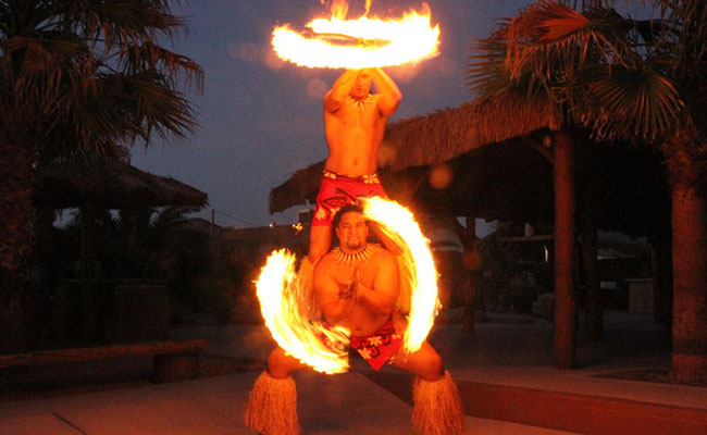 two male polynesian fire knife dancers